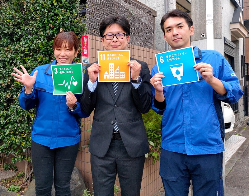 SDGsロゴを掲げる社員